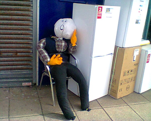 scarecrow outside electrical store